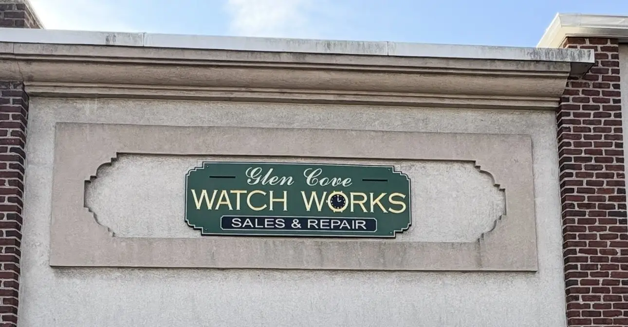 The Glen Cove Watch Works shopfront with its green sign